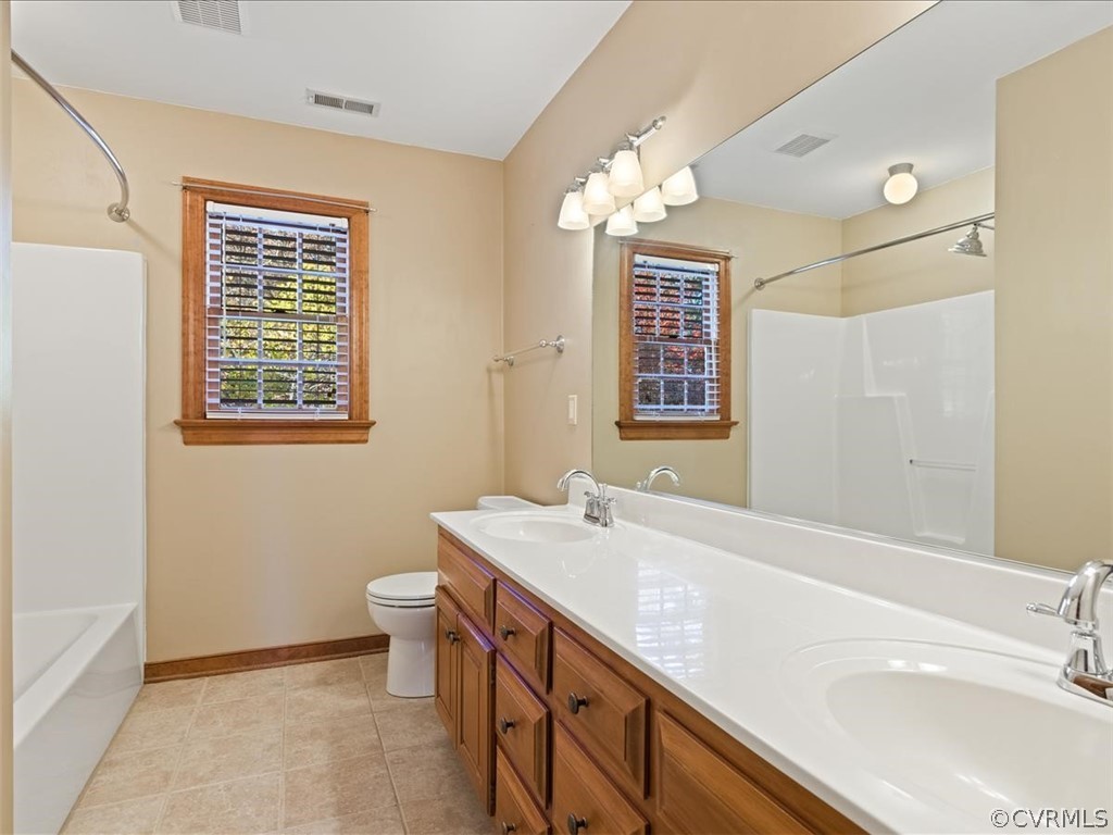 13630 Spring Run Road Midlothian, VA 23112 - Photo 19 of 30 a bathroom with a sink a vanity and a mirror