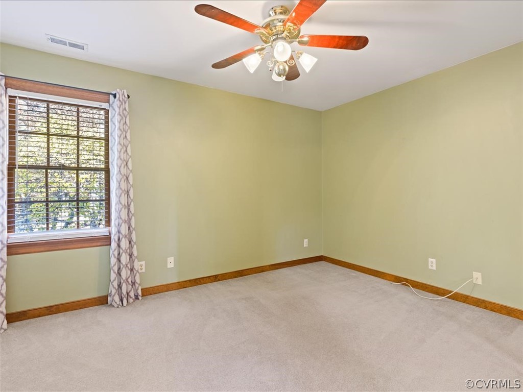 13630 Spring Run Road Midlothian, VA 23112 - Photo 24 of 30 an empty room with windows and chandelier fan