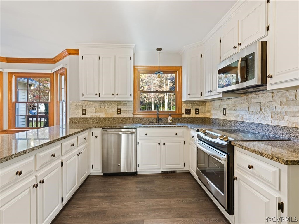 13630 Spring Run Road Midlothian, VA 23112 - Photo 6 of 30 a large white kitchen with stainless steel appliances granite countertop a stove a sink and white cabinets