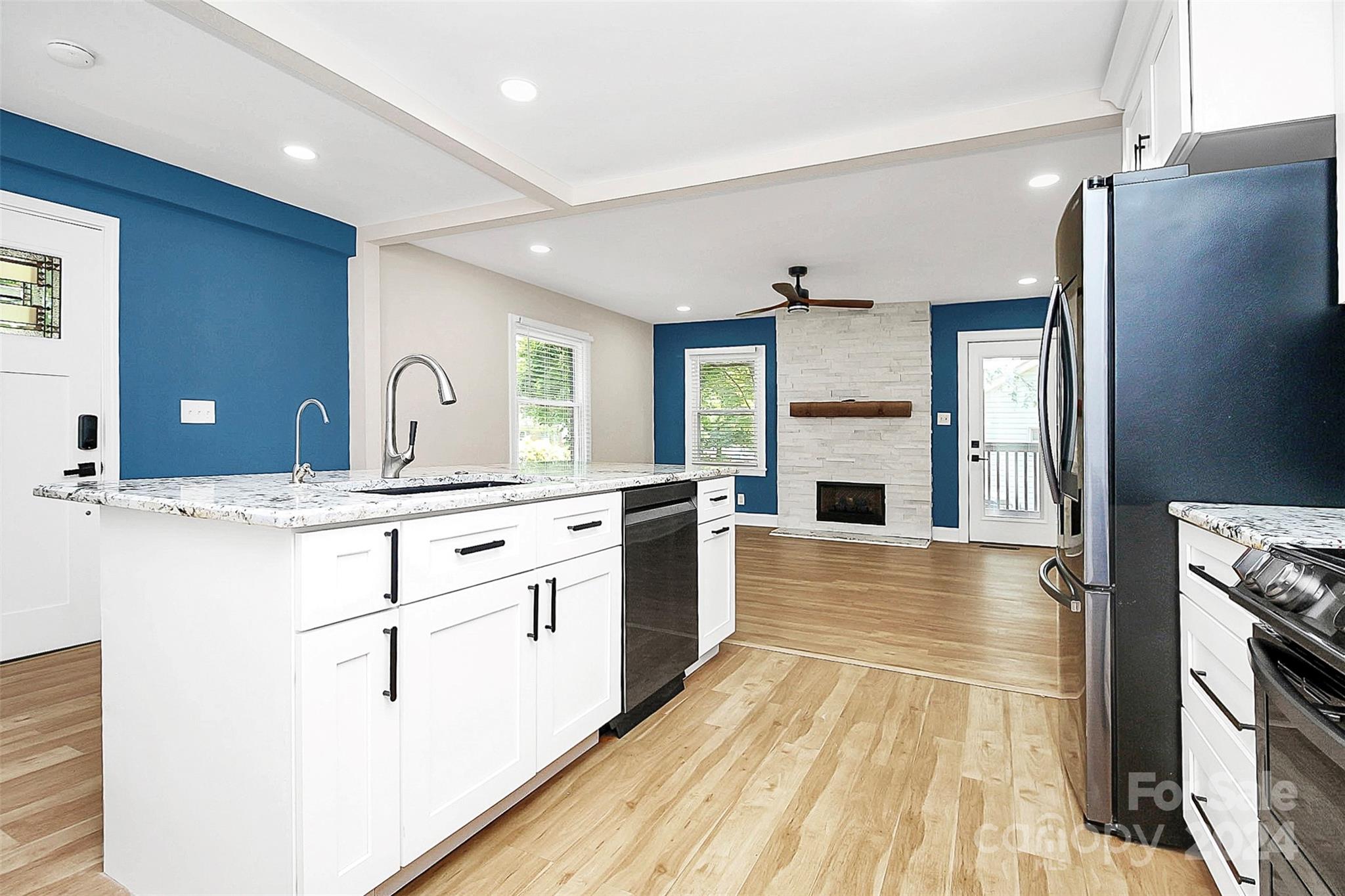 2742 Mayflower Road Charlotte, NC 28208 - Photo 12 of 37 a large kitchen with stainless steel appliances granite countertop a refrigerator a stove and a wooden floors