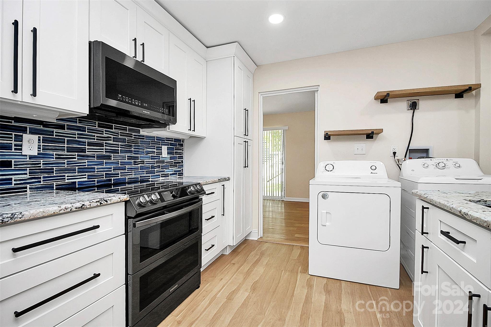 2742 Mayflower Road Charlotte, NC 28208 - Photo 13 of 37 a kitchen with a stove microwave and cabinets