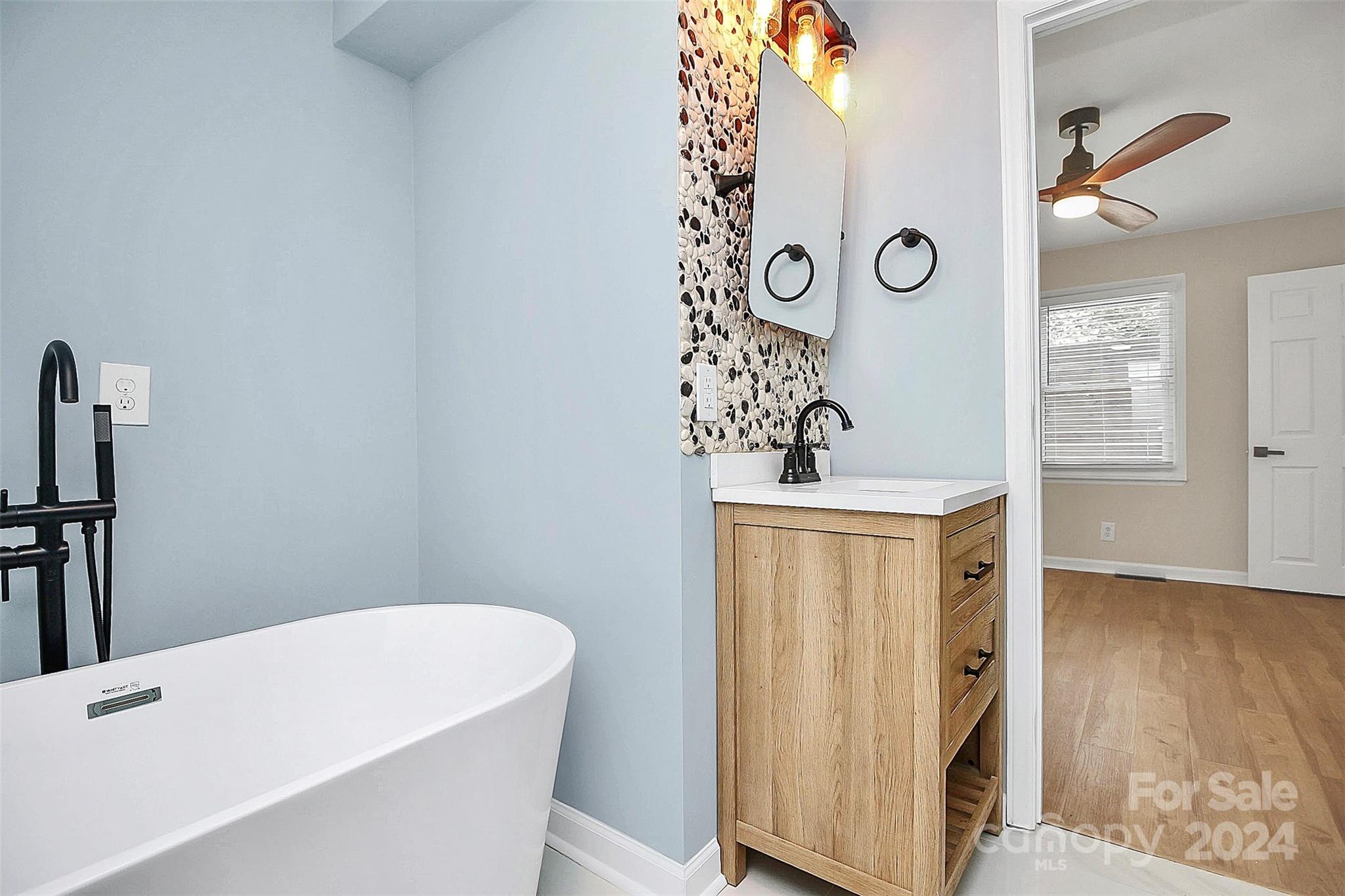 2742 Mayflower Road Charlotte, NC 28208 - Photo 19 of 37 a bathroom with a bathtub and shower