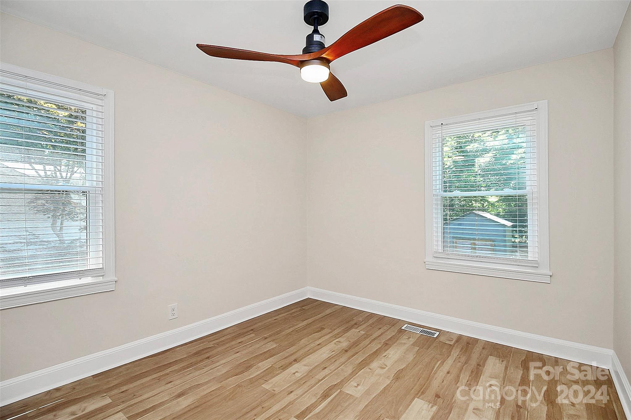 2742 Mayflower Road Charlotte, NC 28208 - Photo 23 of 37 a view of an empty room with wooden floor and a window