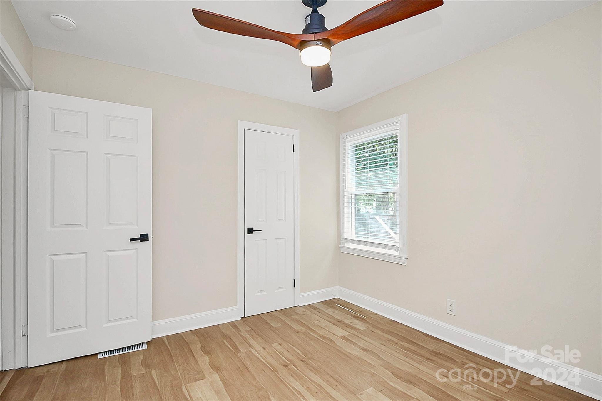 2742 Mayflower Road Charlotte, NC 28208 - Photo 24 of 37 a view of an empty room with wooden floor and a window