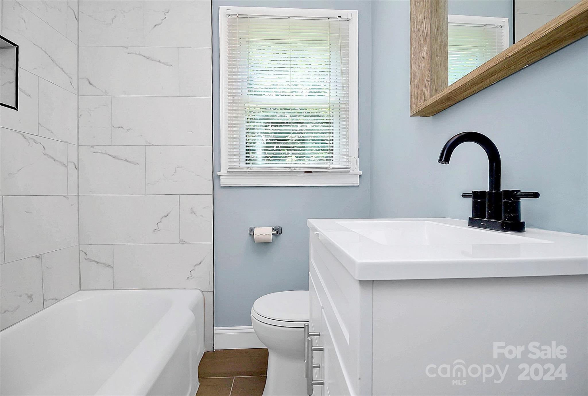 2742 Mayflower Road Charlotte, NC 28208 - Photo 25 of 37 a bathroom with a sink a toilet and bathtub