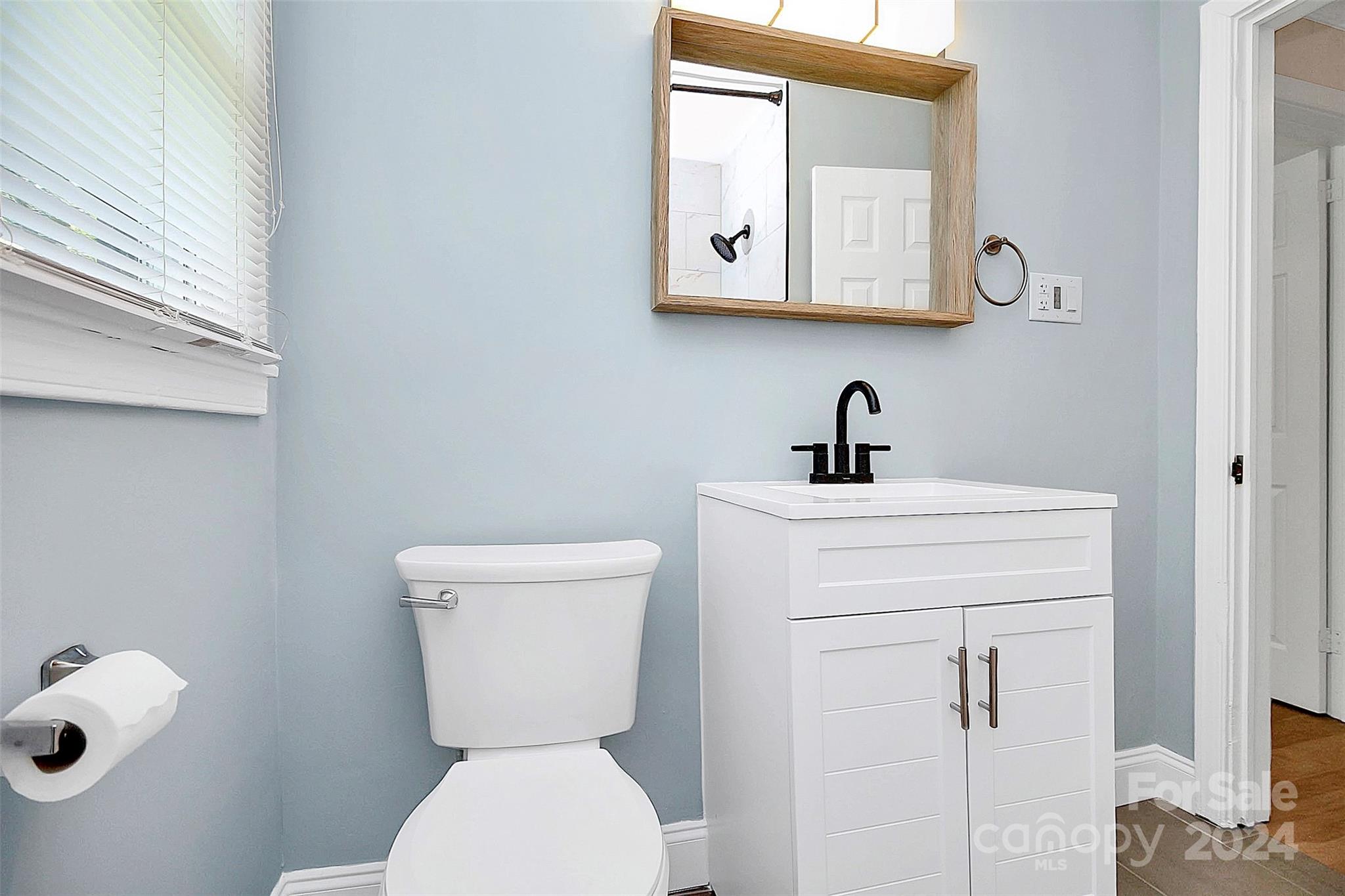2742 Mayflower Road Charlotte, NC 28208 - Photo 27 of 37 a bathroom with a toilet a sink and mirror