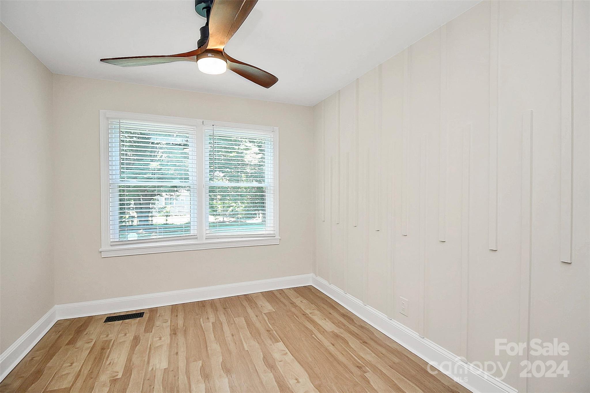 2742 Mayflower Road Charlotte, NC 28208 - Photo 28 of 37 a view of an empty room with wooden floor and a window