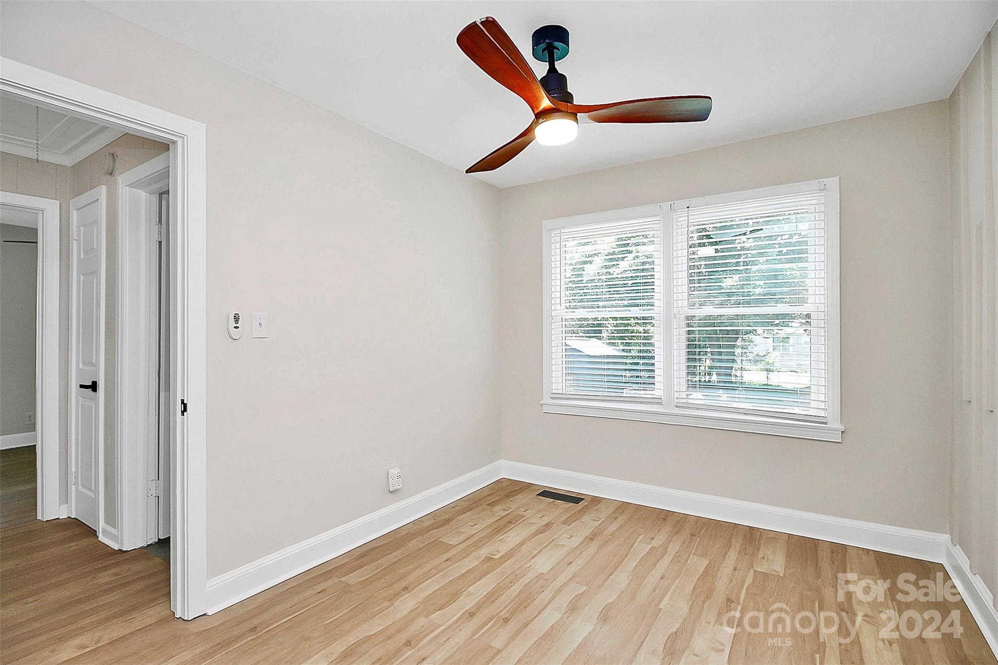 2742 Mayflower Road Charlotte, NC 28208 - Photo 29 of 37 a view of an empty room with wooden floor and a window