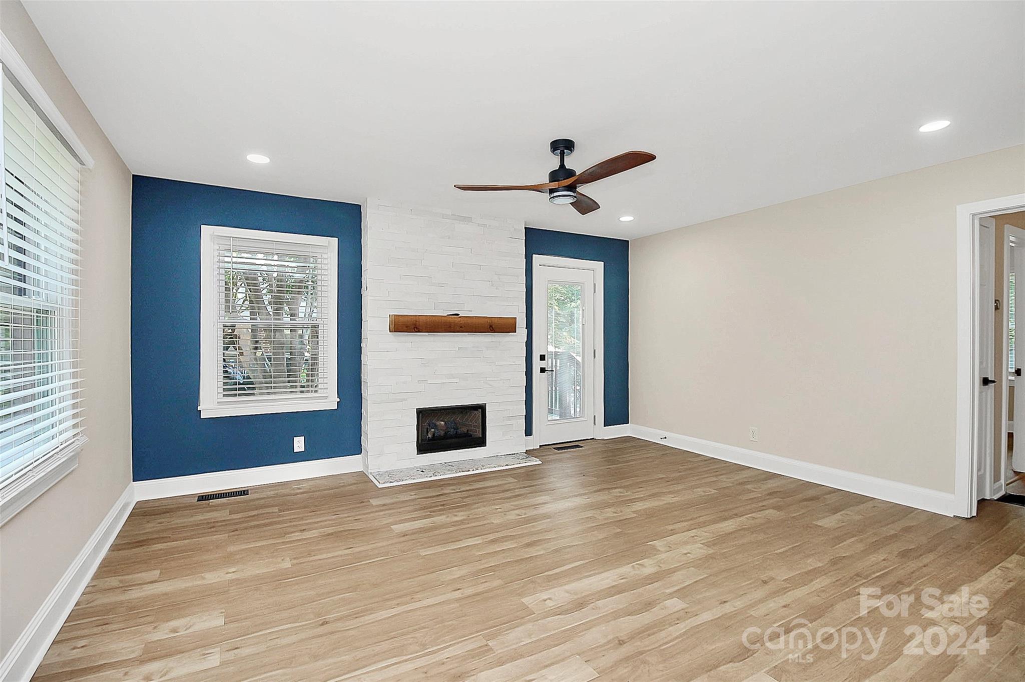 2742 Mayflower Road Charlotte, NC 28208 - Photo 5 of 37 a view of empty room with a fireplace and wooden floor
