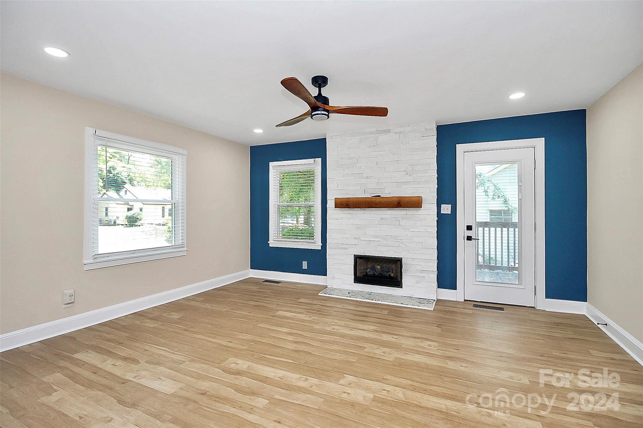 2742 Mayflower Road Charlotte, NC 28208 - Photo 6 of 37 wooden floor fireplace and windows in an empty room