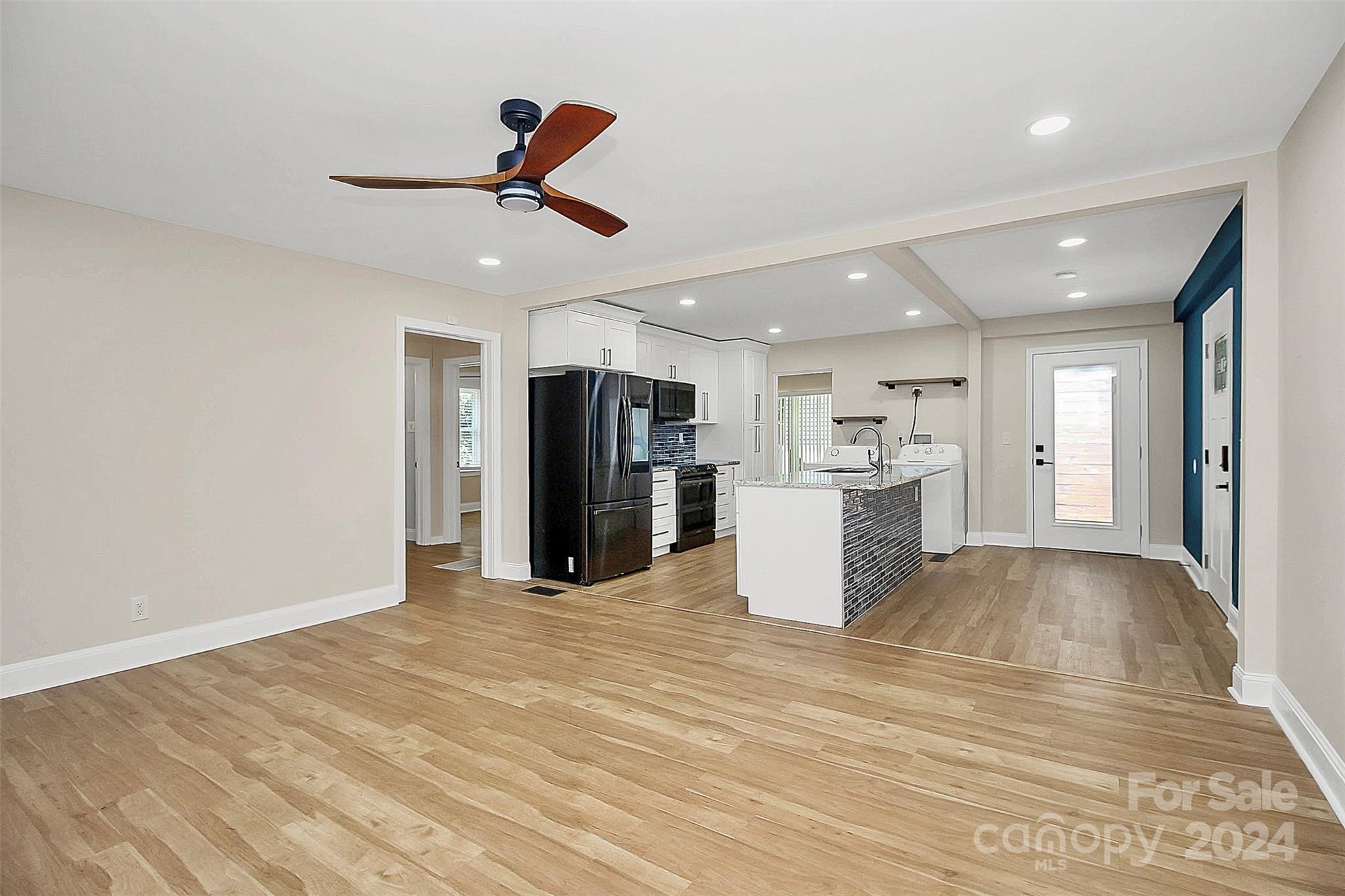2742 Mayflower Road Charlotte, NC 28208 - Photo 7 of 37 a view of a kitchen with refrigerator and a ceiling fan