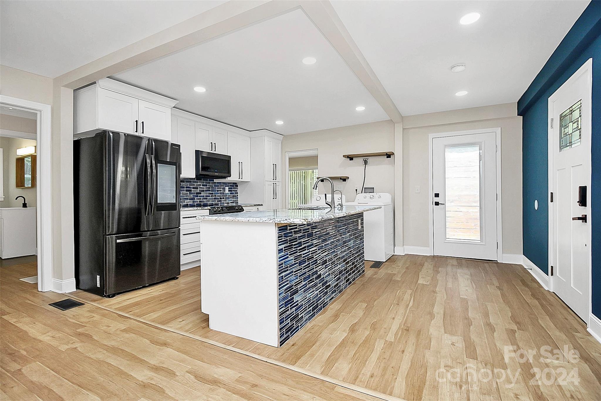 2742 Mayflower Road Charlotte, NC 28208 - Photo 10 of 37 a kitchen with stainless steel appliances a refrigerator and a stove top oven