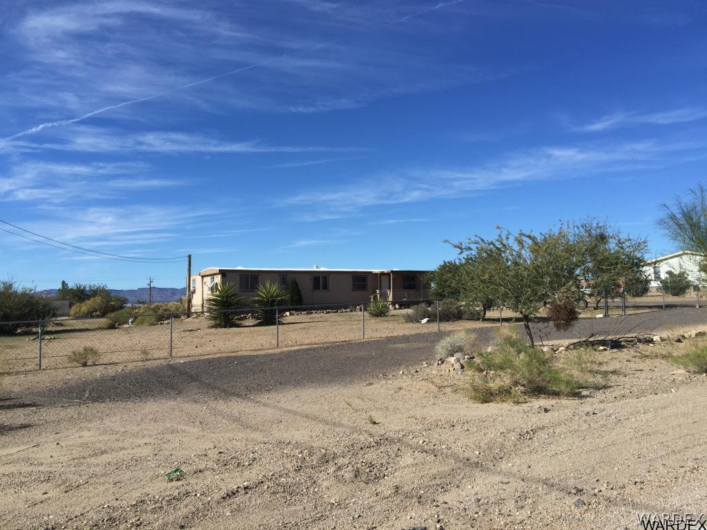 3293 Heber Road Golden Valley, AZ 86413 - Photo 1 of 22 a view of a dry yard with wooden fence