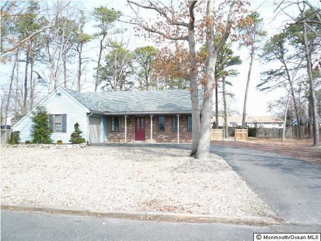 131 Launch Road Manahawkin, NJ 08050 - Photo 1 of 25 a front view of a house with a yard and garage
