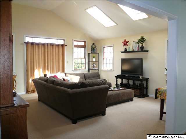 131 Launch Road Manahawkin, NJ 08050 - Photo 11 of 25 a living room with furniture and a flat screen tv