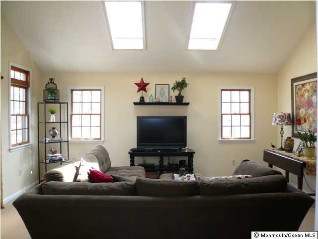 131 Launch Road Manahawkin, NJ 08050 - Photo 13 of 25 a living room with furniture and a flat screen tv
