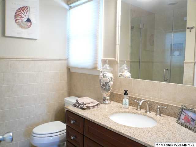 131 Launch Road Manahawkin, NJ 08050 - Photo 14 of 25 a bathroom with a granite countertop sink a toilet and a mirror