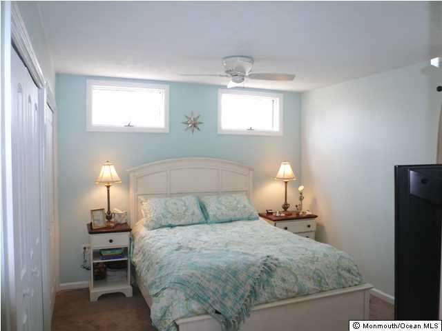 131 Launch Road Manahawkin, NJ 08050 - Photo 16 of 25 a bedroom with a bed and a lamp