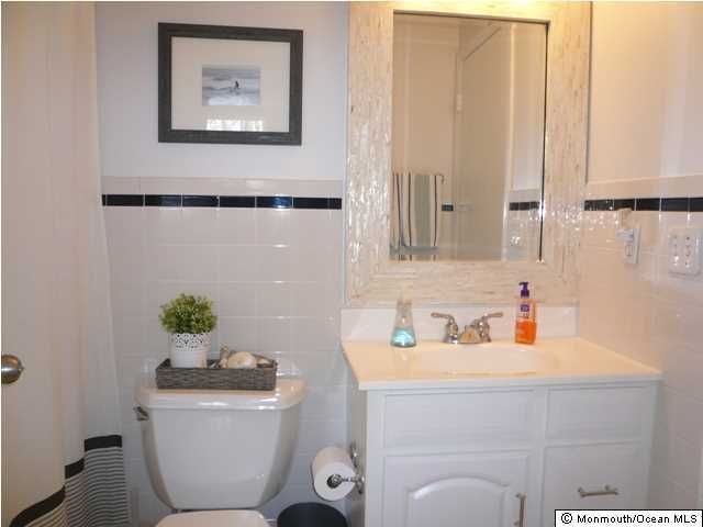 131 Launch Road Manahawkin, NJ 08050 - Photo 17 of 25 a bathroom with a toilet sink and mirror