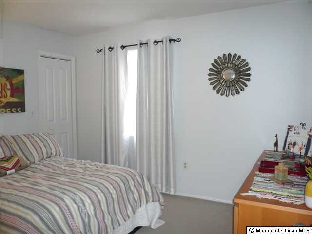 131 Launch Road Manahawkin, NJ 08050 - Photo 18 of 25 a bedroom with a bed and a window