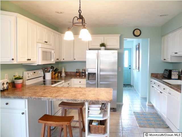 131 Launch Road Manahawkin, NJ 08050 - Photo 7 of 25 a kitchen with stainless steel appliances granite countertop a sink a stove and refrigerator