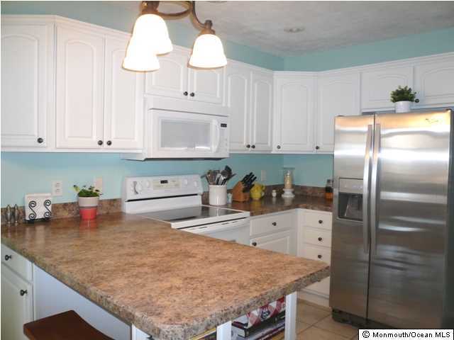 131 Launch Road Manahawkin, NJ 08050 - Photo 8 of 25 a kitchen with stainless steel appliances granite countertop a sink a stove and a refrigerator