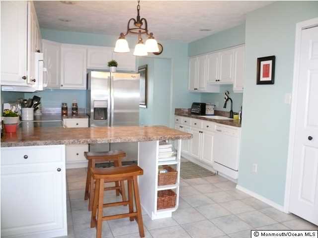 131 Launch Road Manahawkin, NJ 08050 - Photo 9 of 25 a kitchen with kitchen island granite countertop counter top space appliances and cabinets