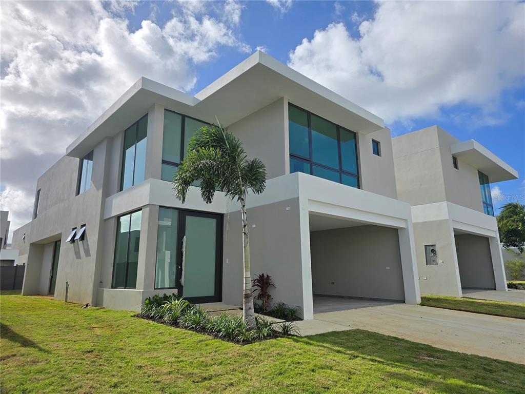 101 Tayrona Street, Unit 101 Bayamon, PR 00959 - Photo 1 of 1 a front view of a house with yard