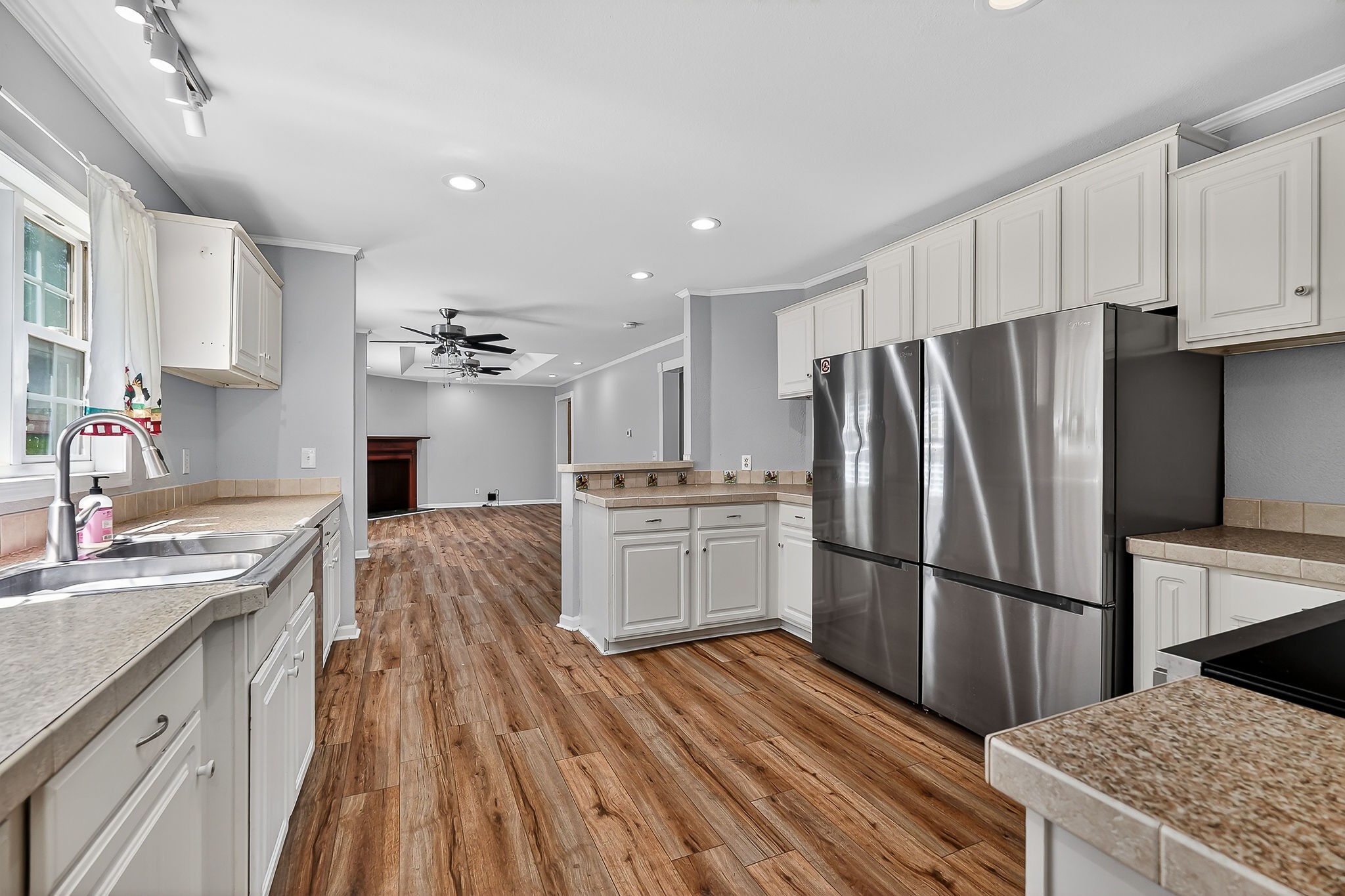 16130 Buffalo Valley Road Silver Point, TN 38582 - Photo 28 of 47 a kitchen with granite countertop a refrigerator oven a sink dishwasher and white cabinets with wooden floor