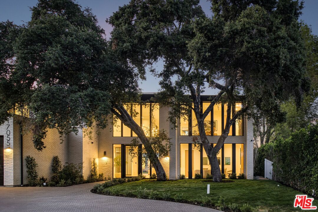 17055 Rancho Street Encino, CA 91316 - Photo 65 of 73 front view of house with a yard and trees