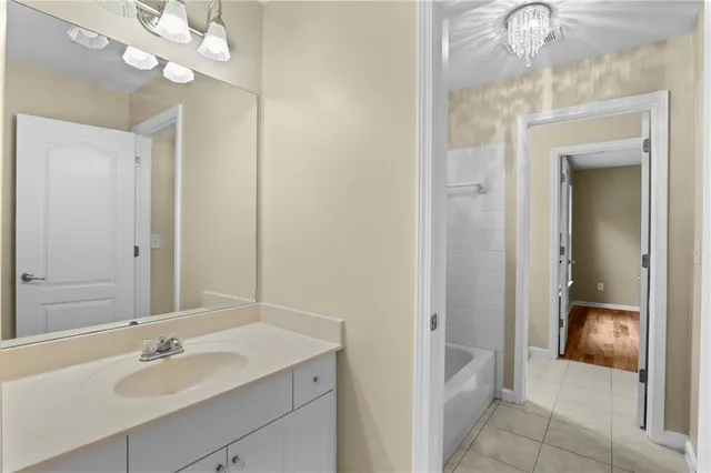 a bathroom with a sink vanity and a mirror