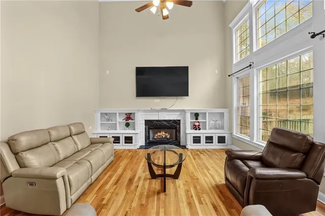 a living room with furniture a fireplace and a flat screen tv
