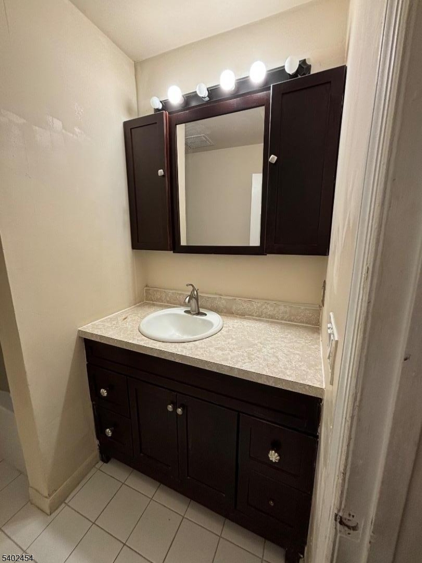 18 Harrison Street Belleville, NJ 07109 - Photo 18 of 18 a bathroom with a granite countertop sink and mirror