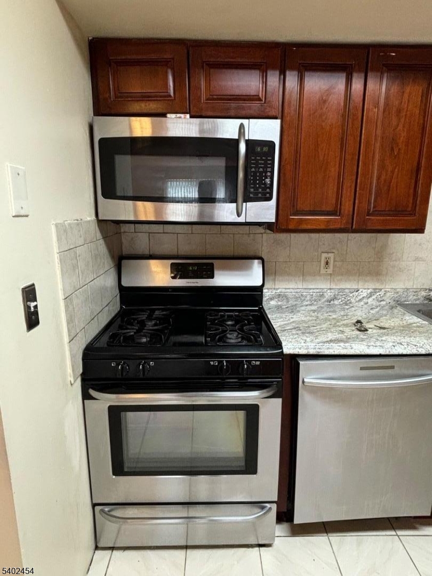 18 Harrison Street Belleville, NJ 07109 - Photo 3 of 18 a stove top oven sitting inside of a kitchen