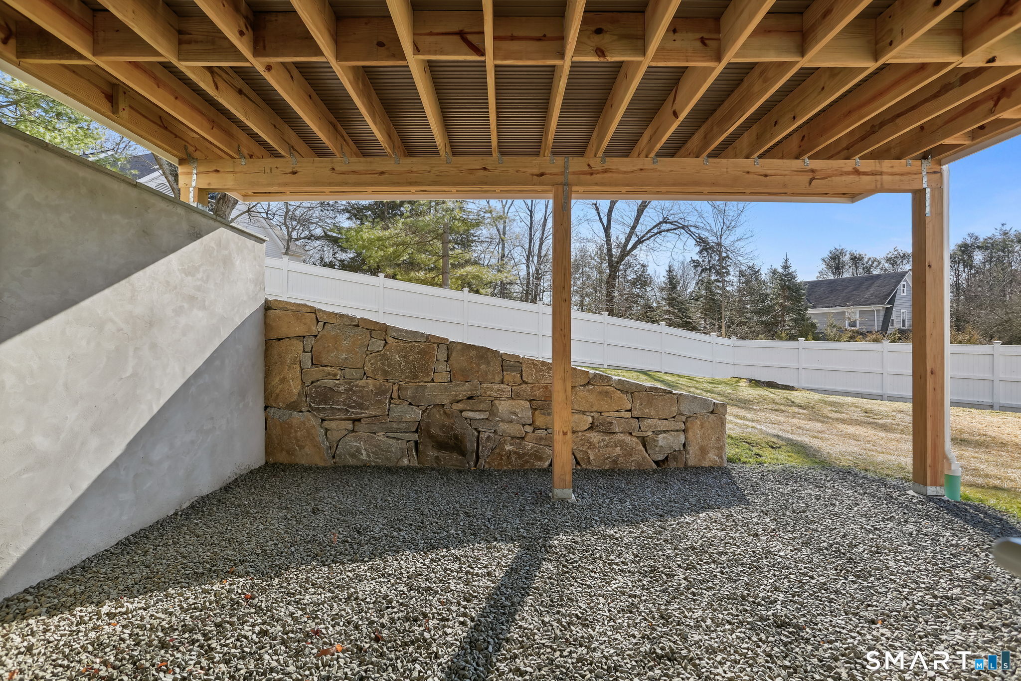 218 Lower Farm Road Fairfield, CT 06824 - Photo 34 of 40 Sliders from lower level open onto covered patio and out into backyard