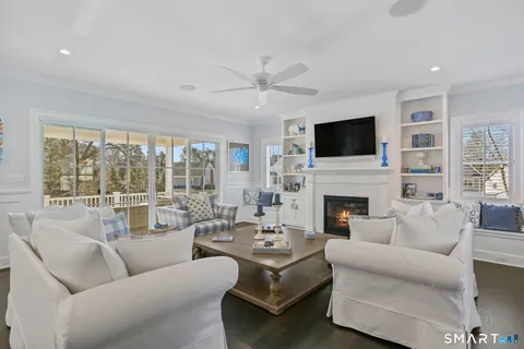 a living room with furniture a fireplace and a flat screen tv
