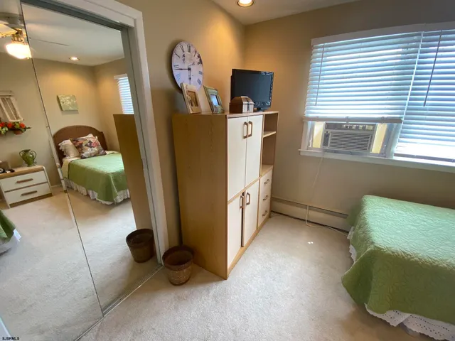 a view of a livingroom with workspace and a window