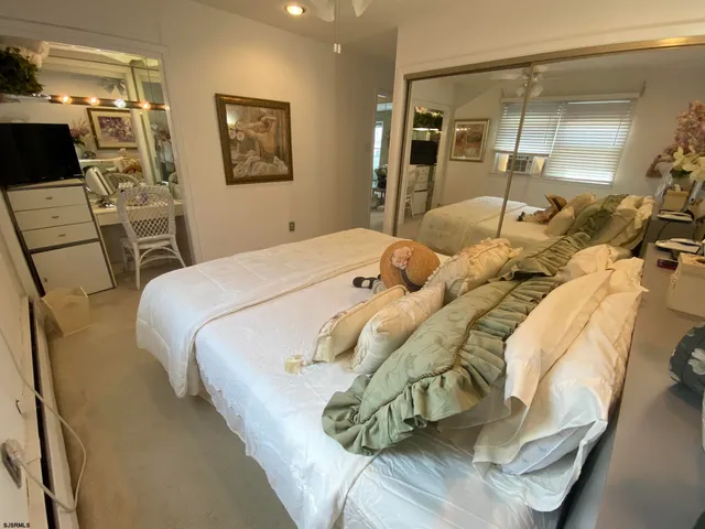 a bedroom with a bed and a mirror