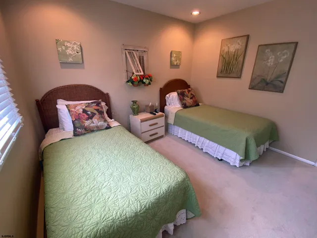 a bedroom with two beds and painting on the wall