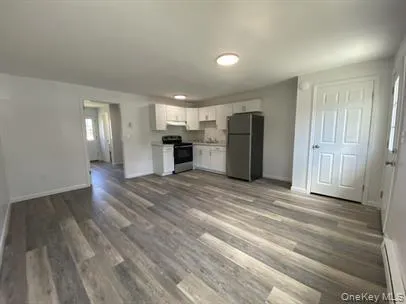 a view of a kitchen with a sink and a refrigerator