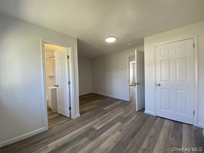 779 Neighborhood Road Lake Katrine, NY 12449 - Photo 6 of 7 Unfurnished bedroom with dark wood finished floors and baseboards