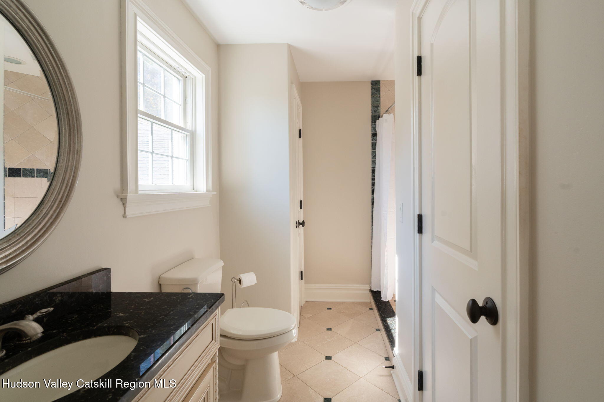 46 Idlewild Road Marlboro, NY 12542 - Photo 18 of 31 a bathroom with a granite countertop toilet a sink and a mirror