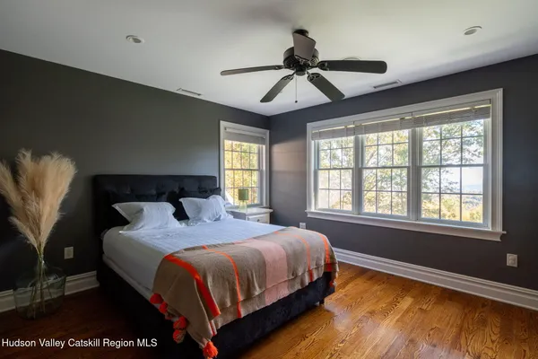 a bedroom with a bed a chandelier and a window