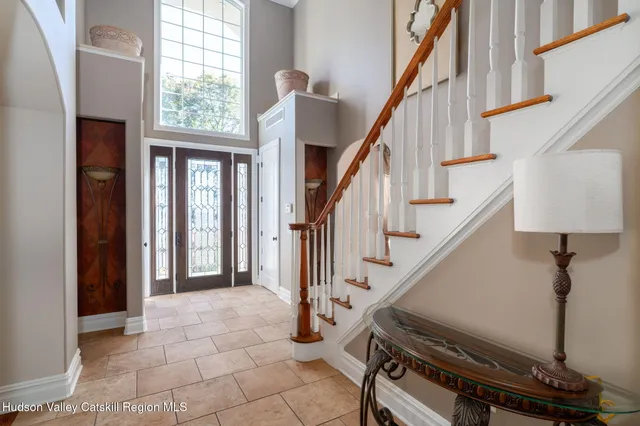 a view of entryway with wooden floor and stairs