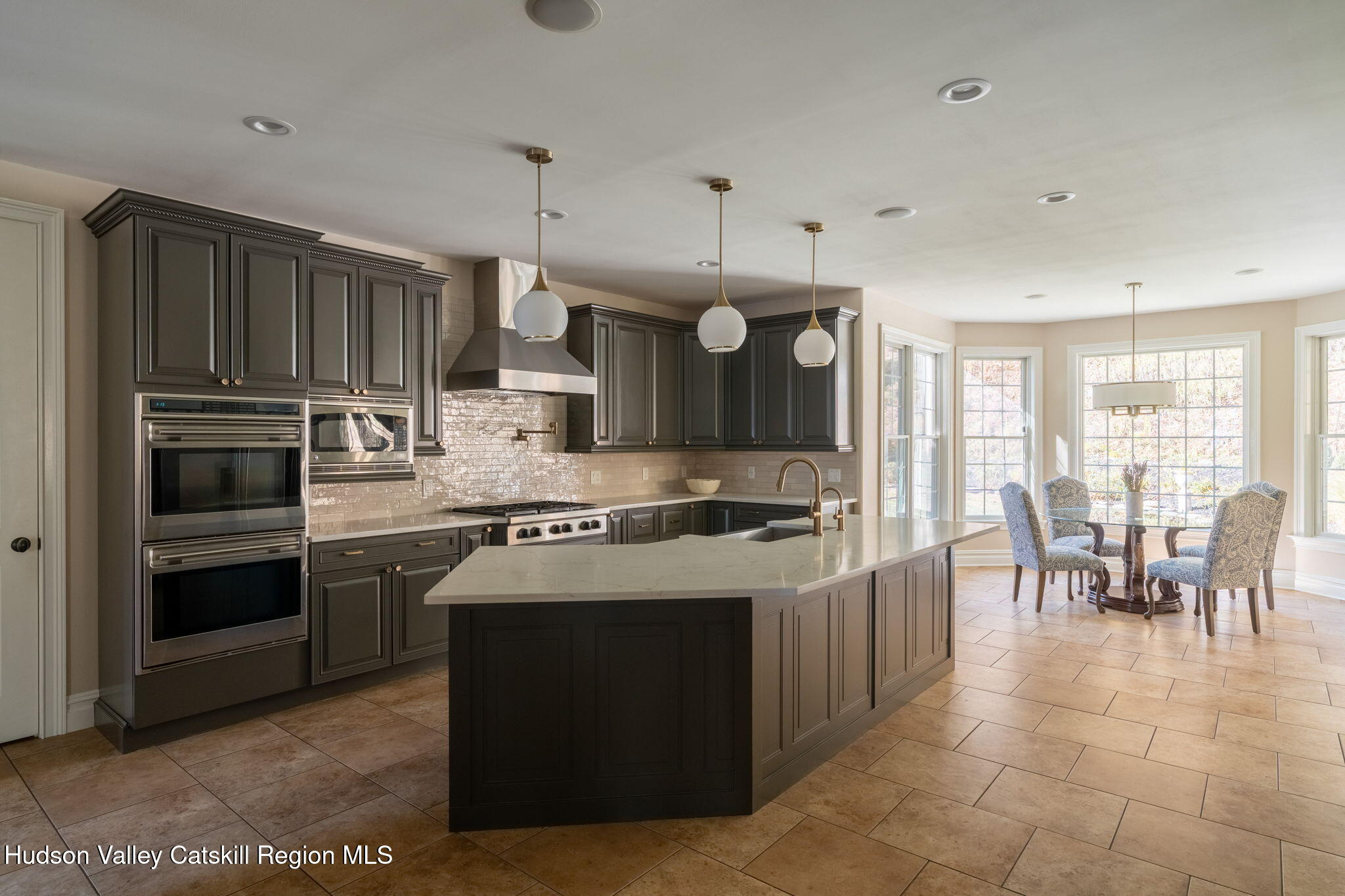 46 Idlewild Road Marlboro, NY 12542 - Photo 10 of 31 a kitchen with stainless steel appliances granite countertop a stove top oven a refrigerator a sink and a dining table