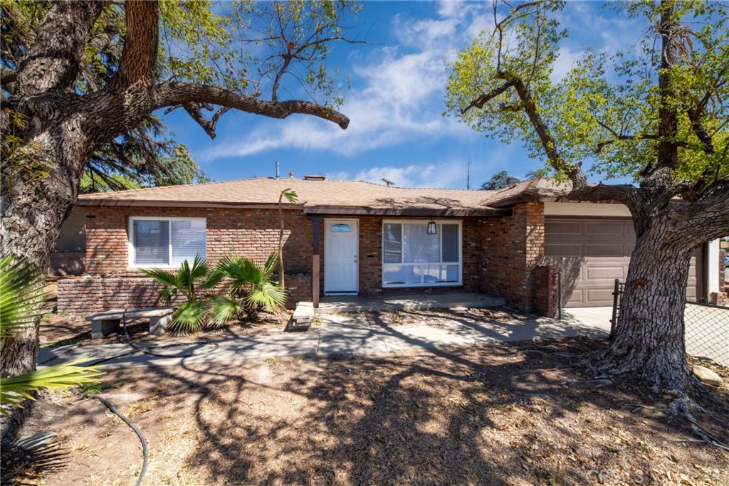 157 South Sycamore Avenue Rialto, CA 92376 - Photo 1 of 1 a view of a house with a tree in a backyard