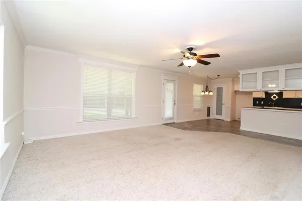 a view of a kitchen with a sink and a chandelier fan