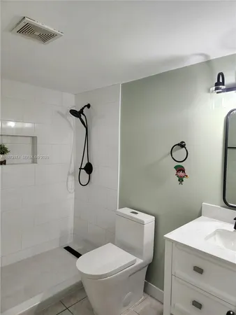 a bathroom with a toilet sink and shower