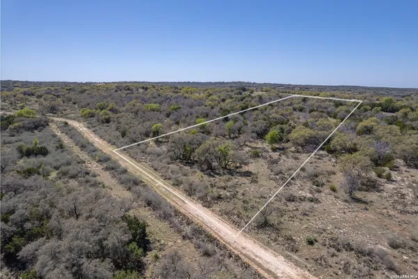 an aerial view of a houses with a yard