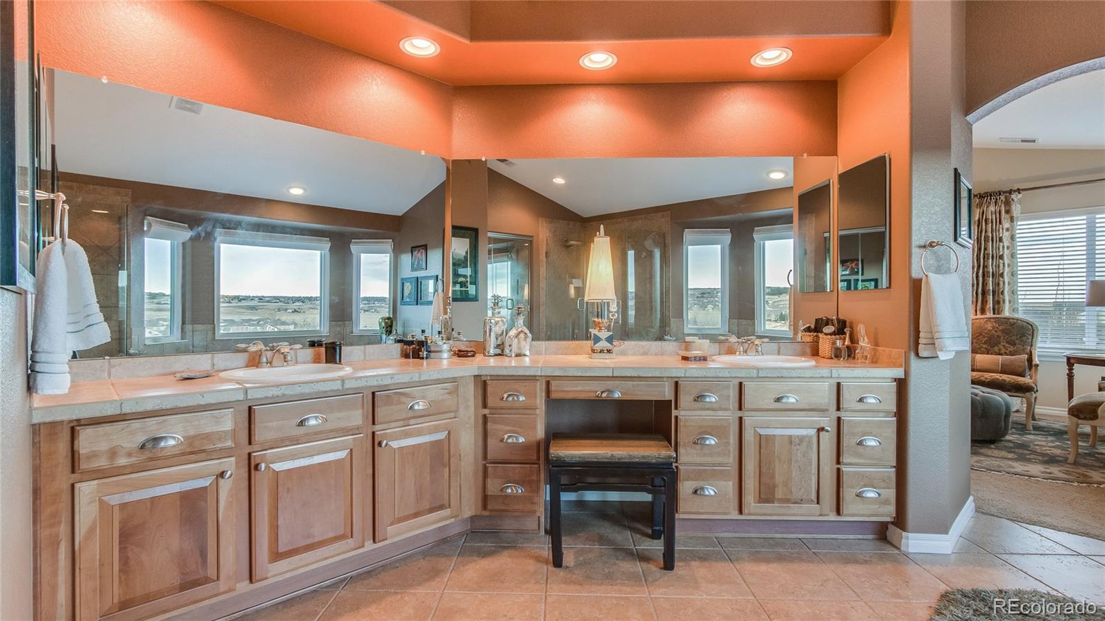 5310 Streambed Trail Parker, CO 80134 - Photo 21 of 35 a large white kitchen with a sink and dishwasher a stove with wooden floor